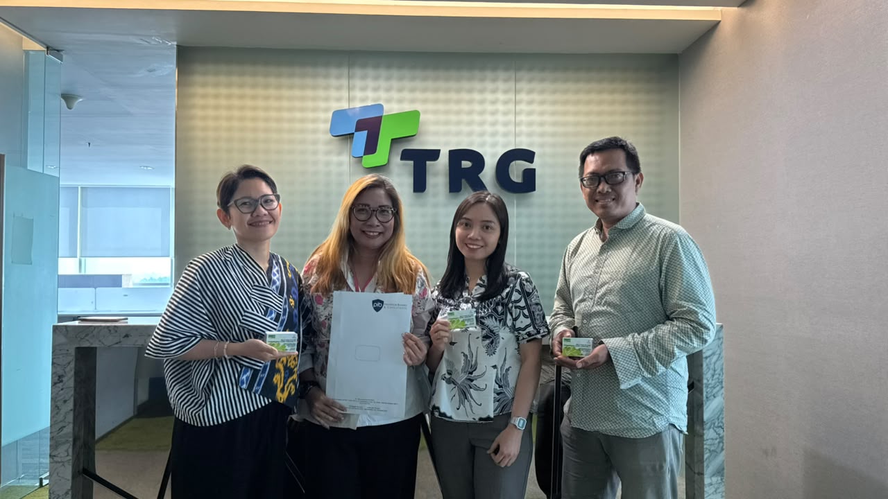 TRG team receiving health insurance membership cards
